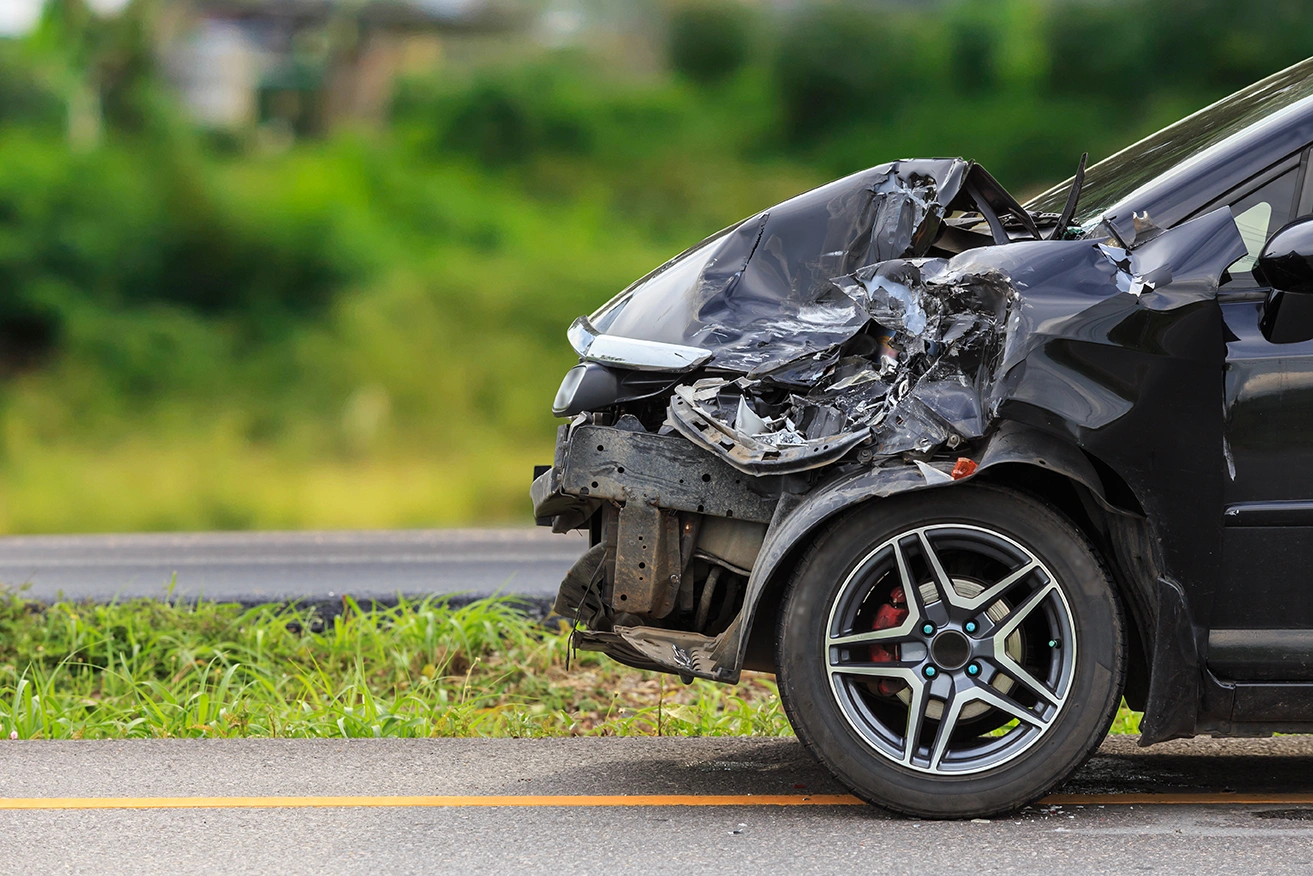 Black car that's been involved in a front end crash