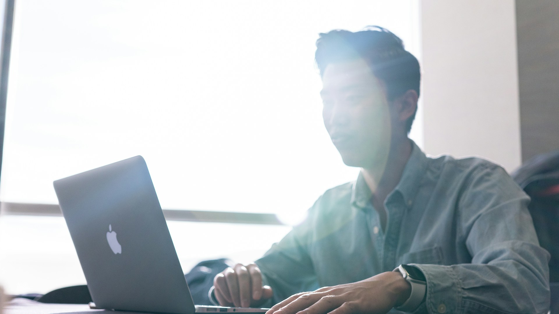 A man sat on his computer 